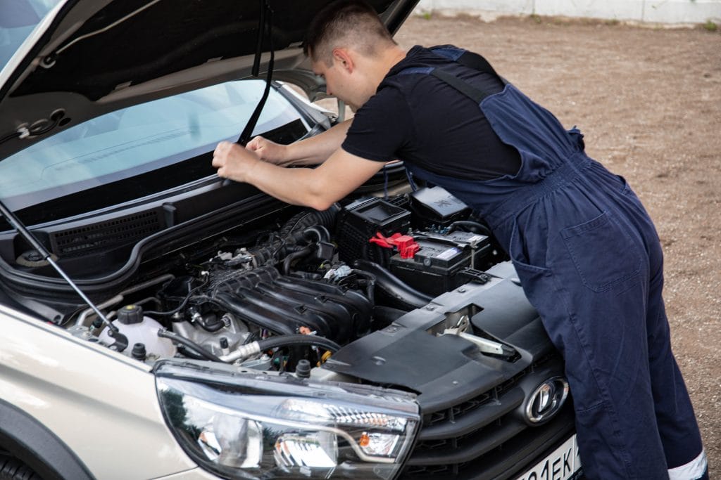 Cost of car ownership: mechanic performing car repair