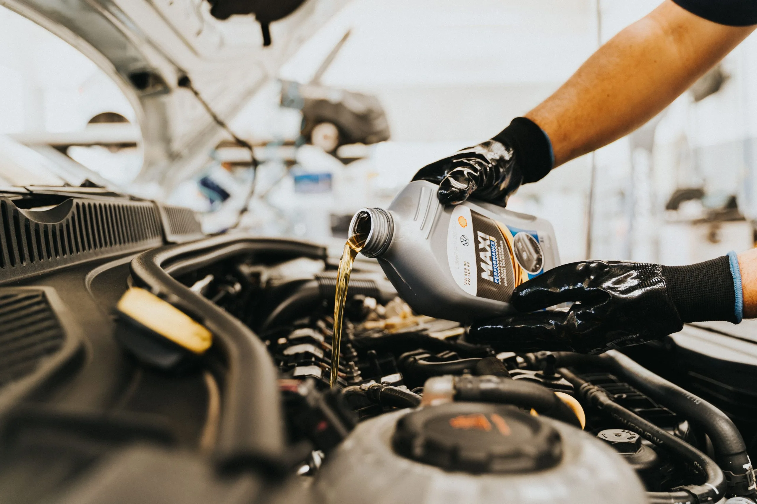 Oil change interval: mechanic changing car engine oil
