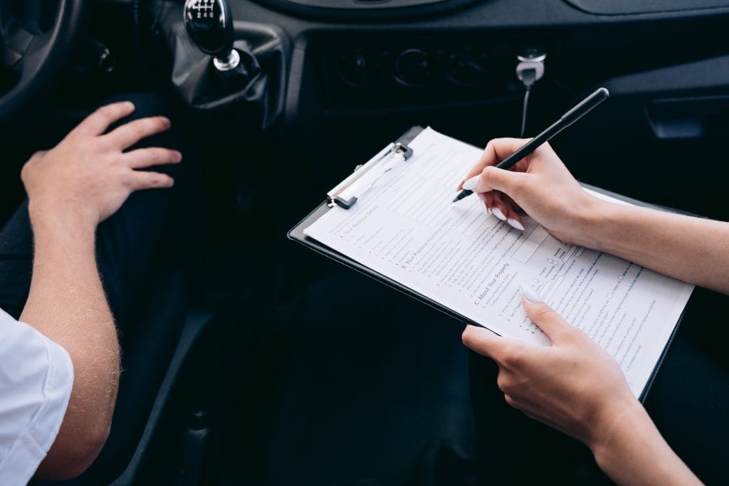 Car insurance agent reviewing paperwork