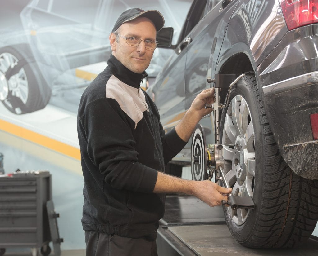 Brake pad warning signs: checking pad thickness through wheel