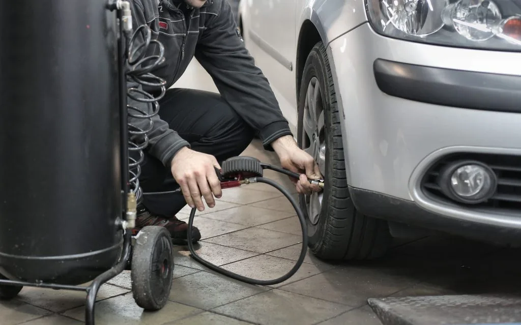 Extend tire life: checking tire pressure with gauge
