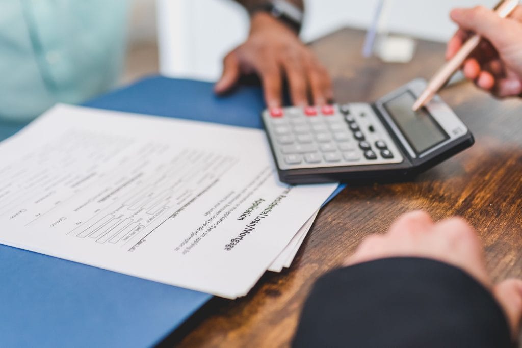 Buyer reviewing pre-approved car financing documents before negotiating a used car deal